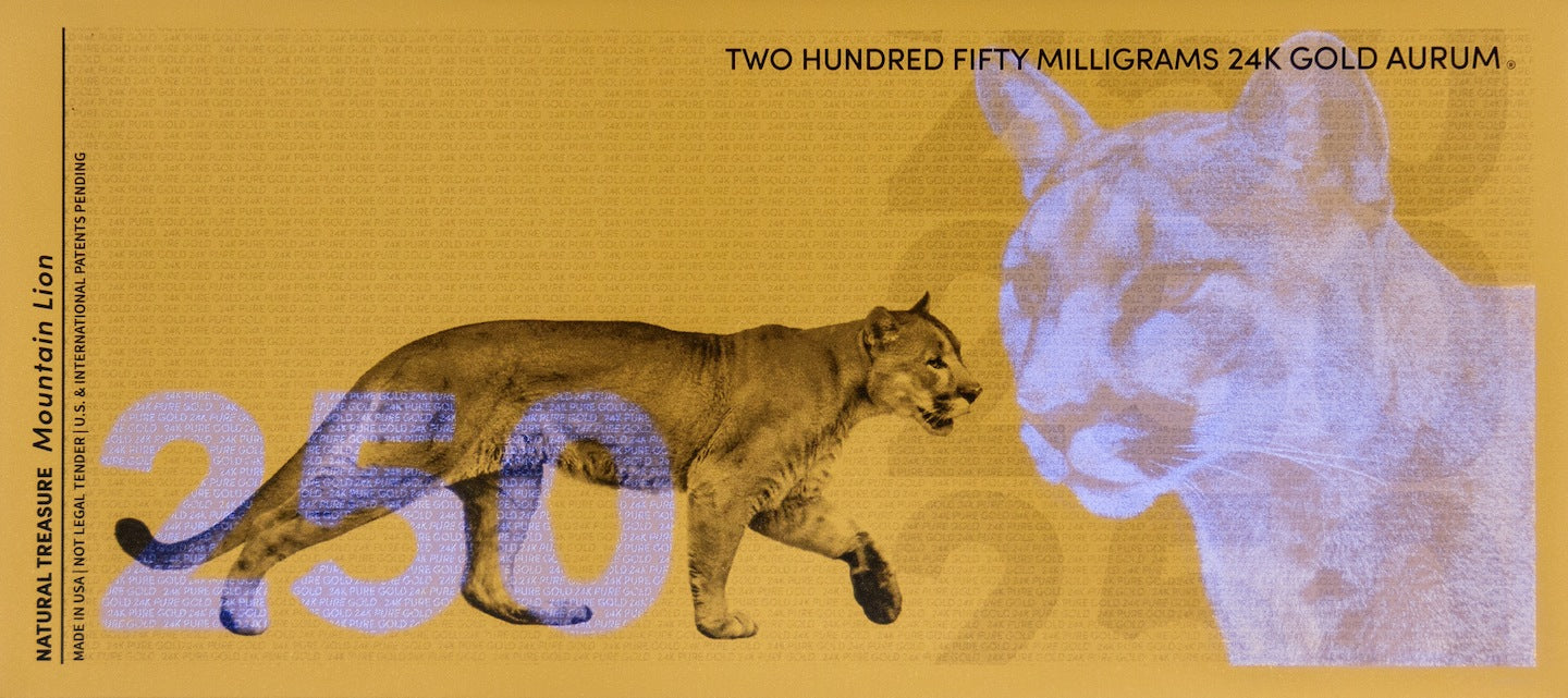 reverse of 250mg gold aurum mountain lion bill showing the uv designs