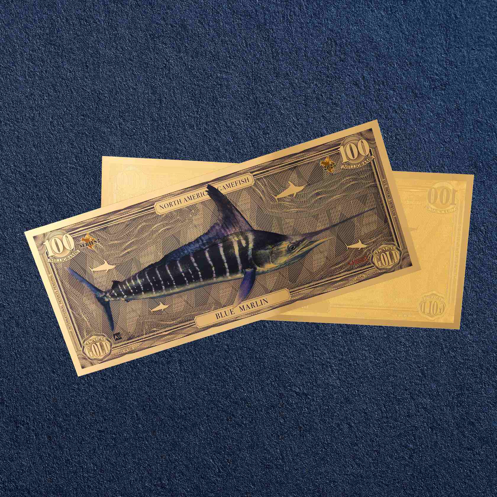 the blue marlin north american gamefish bill with 100mg of 24k gold shown obverse over reverse