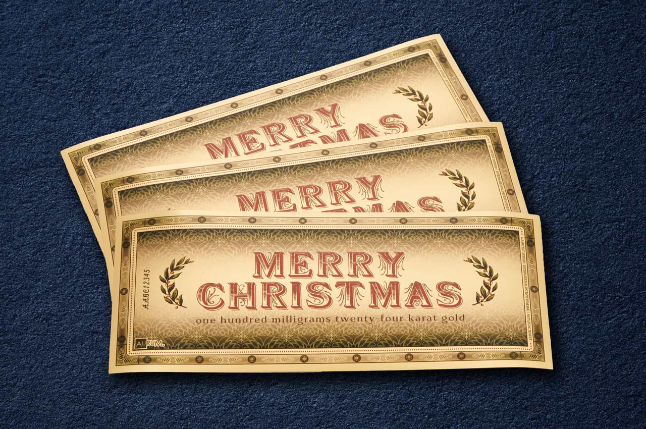 giftable merry christmas aurum with 100 milligrams 24 karat gold and festive design shown fanned