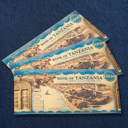 stack of legal tender gold backed bills from tanzania with 1,000 shillings each