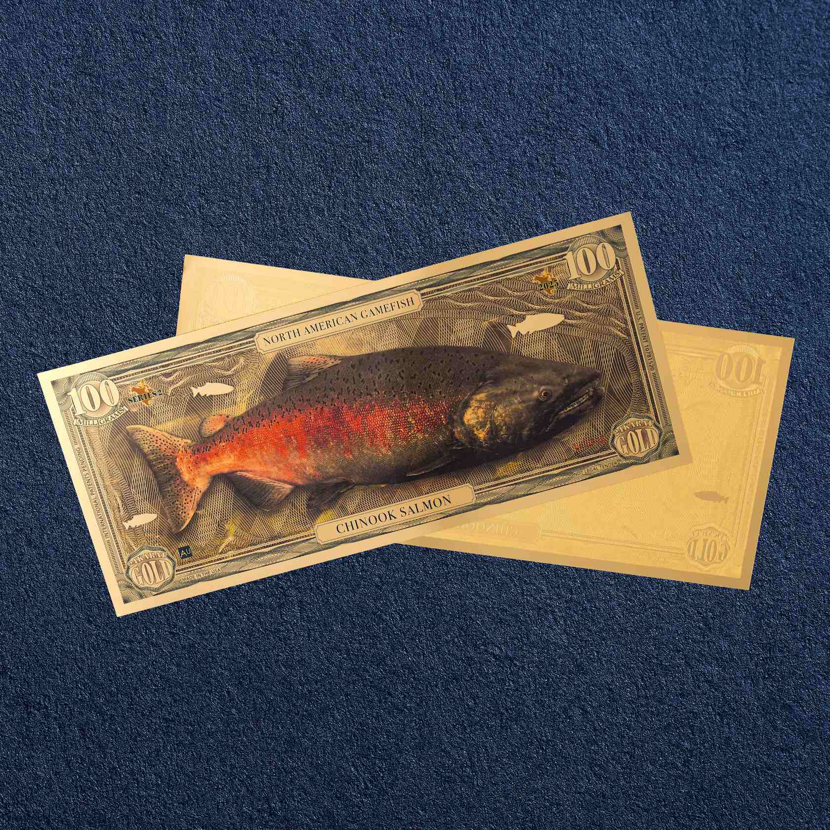 the chinook salmon north american gamefish bill with 100mg of 24k gold shown obverse over reverse