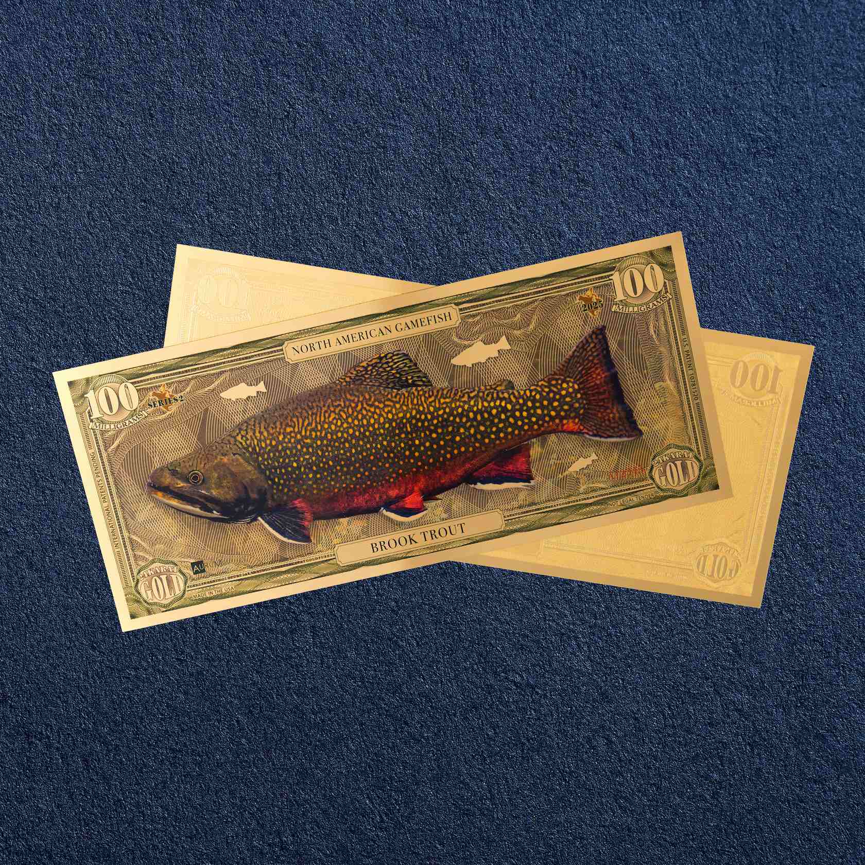 the brook trout north american gamefish bill with 100mg of 24k gold shown obverse over reverse